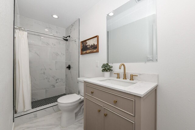 7113 N Navajo Ave, Glendale, WI 53217 - bathroom with marble finish flooring, a tile shower, toilet, vanity, and recessed lighting