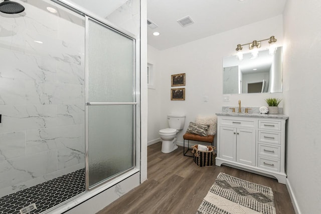 7113 N Navajo Ave, Glendale, WI 53217 - bathroom with a stall shower, wood finished floors, toilet, baseboards, and recessed lighting