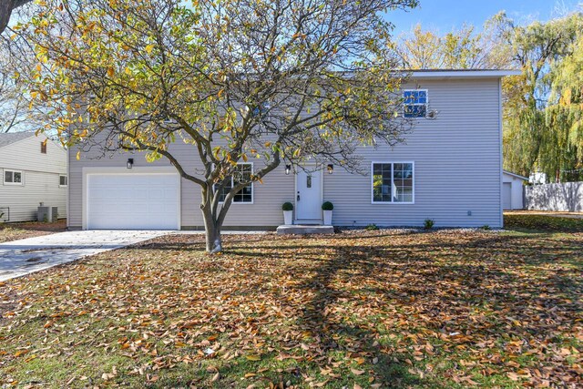 7113 N Navajo Ave, Glendale, WI 53217 - view of front of house featuring concrete driveway, a garage, and central AC