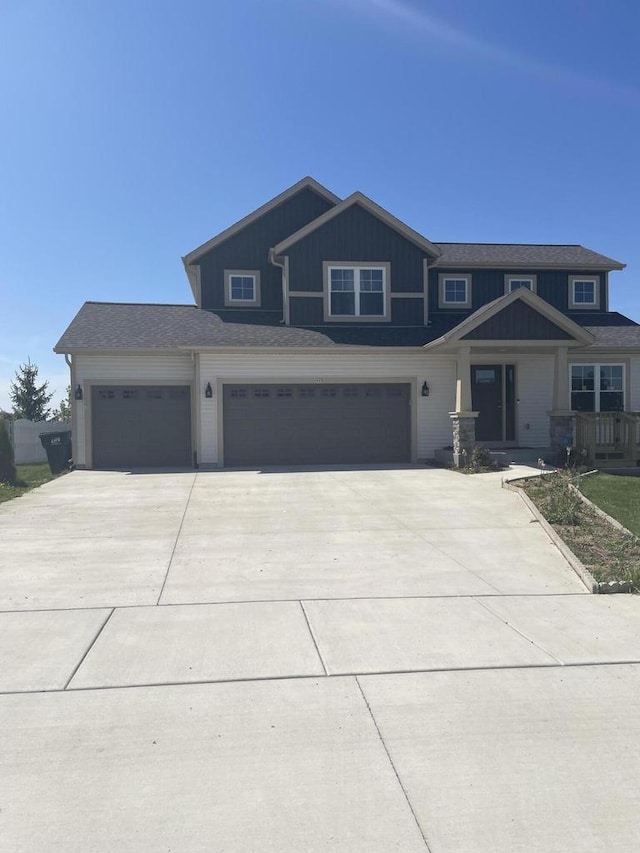 425 Champlain Dr, Johnson Creek, WI 53038 - view of front of property featuring concrete driveway, board and batten siding, and a garage