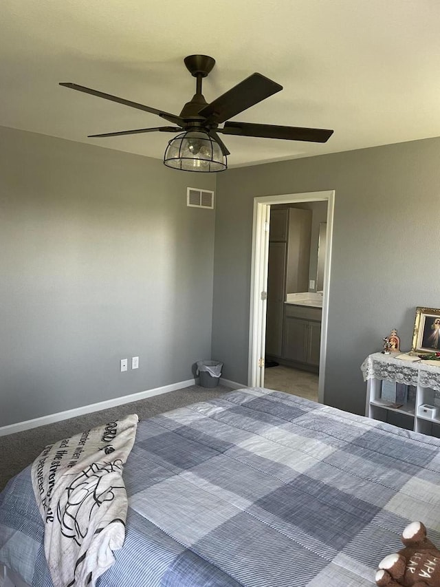 425 Champlain Dr, Johnson Creek, WI 53038 - carpeted bedroom featuring baseboards, connected bathroom, and a ceiling fan
