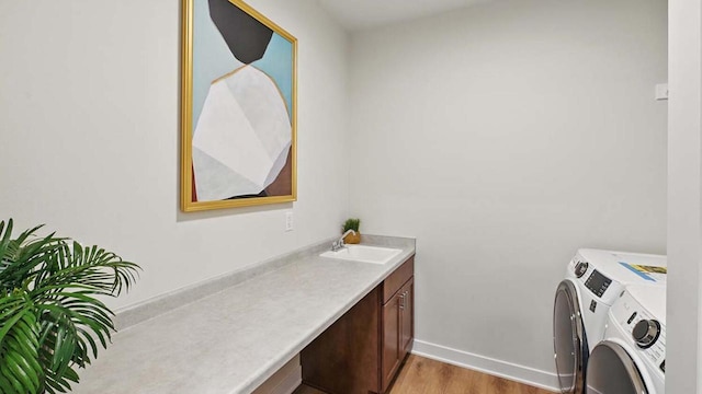 1117 5th Ave Unit Lt38, Union Grove, WI 53182 - laundry area featuring washing machine and clothes dryer, light wood-style flooring, cabinet space, and baseboards