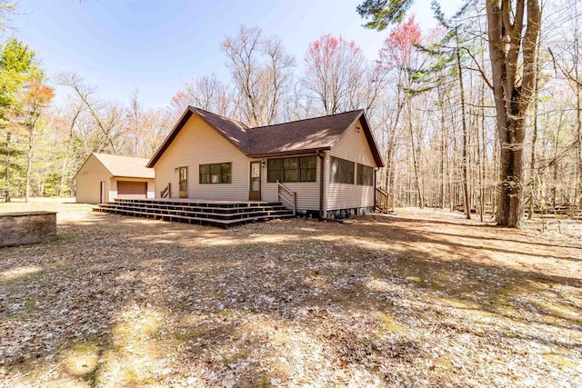 1809 S Badger Ct, Arkdale, WI 54613 - view of home's exterior with a sunroom, a wooden deck, and a detached garage