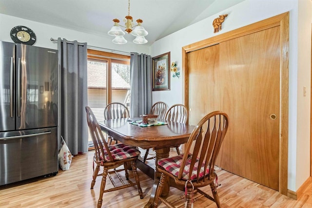 1809 S Badger Ct, Arkdale, WI 54613 - dining area with lofted ceiling, a chandelier, and light wood-style floors