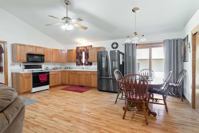 1809 S Badger Ct, Arkdale, WI 54613 - kitchen with range with gas cooktop, freestanding refrigerator, black microwave, light countertops, and light wood finished floors