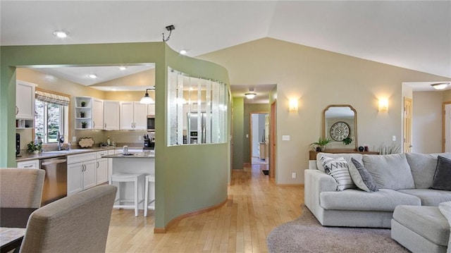 2649 W Menomonie St, Eau Claire, WI 54703 - living area featuring vaulted ceiling, light wood-style floors, and baseboards