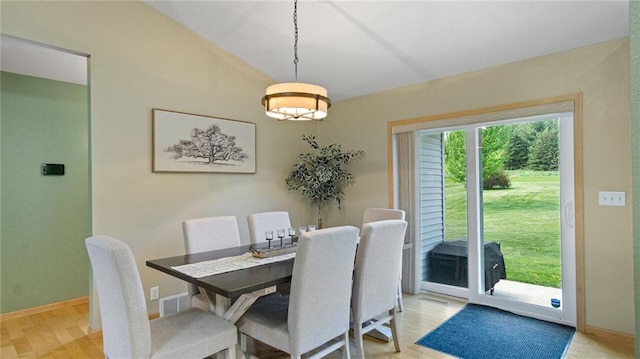 2649 W Menomonie St, Eau Claire, WI 54703 - dining room featuring light wood-style flooring, vaulted ceiling, and baseboards