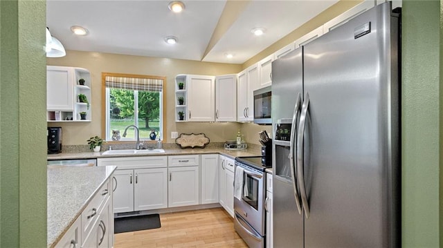 2649 W Menomonie St, Eau Claire, WI 54703 - kitchen featuring stainless steel appliances, a sink, open shelves, white cabinets, and light wood-style flooring