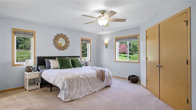 2649 W Menomonie St, Eau Claire, WI 54703 - bedroom with light colored carpet, baseboards, ceiling fan, and a closet