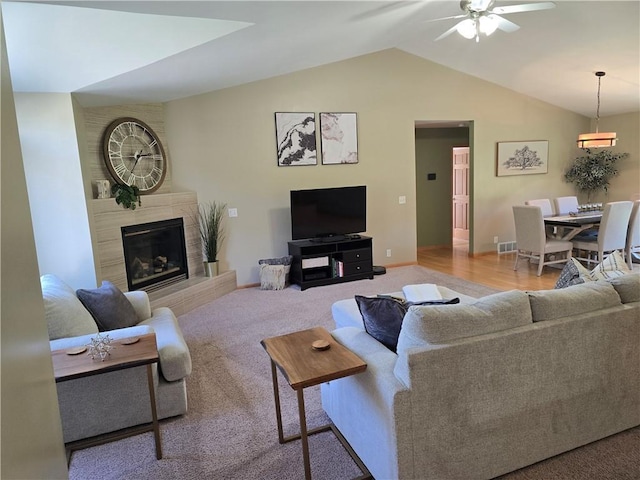2649 W Menomonie St, Eau Claire, WI 54703 - carpeted living area with ceiling fan, vaulted ceiling, a tile fireplace, and baseboards