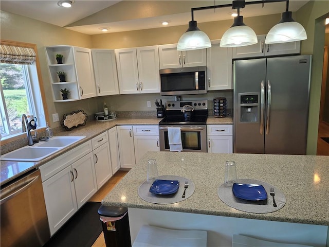 2649 W Menomonie St, Eau Claire, WI 54703 - kitchen featuring stainless steel appliances, a sink, open shelves, white cabinets, and decorative light fixtures