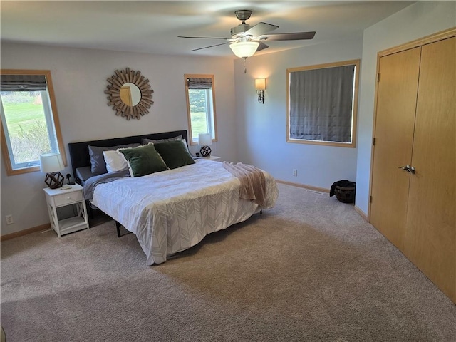 2649 W Menomonie St, Eau Claire, WI 54703 - bedroom featuring light colored carpet, ceiling fan, baseboards, and a closet