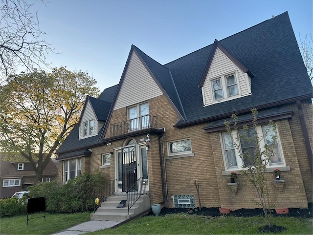 1728 W Capitol Dr, Milwaukee, WI 53206 - view of front of property featuring a balcony, brick siding, and a shingled roof