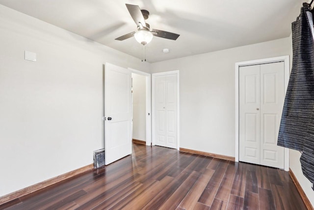 1728 W Capitol Dr, Milwaukee, WI 53206 - unfurnished bedroom with dark wood-style flooring, baseboards, a ceiling fan, and a closet