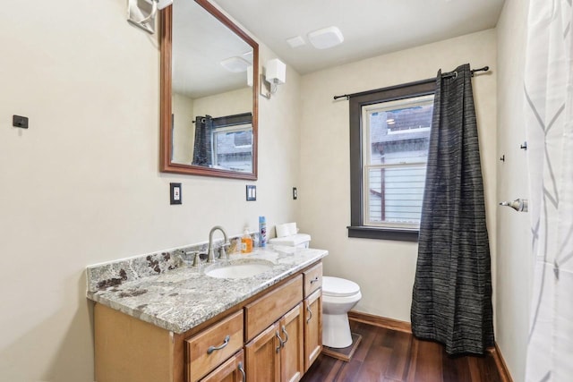 1728 W Capitol Dr, Milwaukee, WI 53206 - bathroom featuring wood finished floors, toilet, vanity, and baseboards