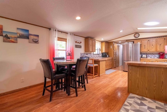 1870 County Road F Unit L69, Friendship, WI 53934 - dining space featuring vaulted ceiling, light wood finished floors, recessed lighting, a textured ceiling, and baseboards