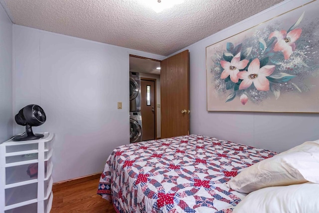 1870 County Road F Unit L69, Friendship, WI 53934 - bedroom with stacked washer and clothes dryer, wood finished floors, and a textured ceiling