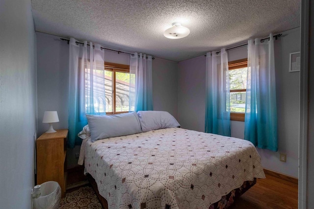 1870 County Road F Unit L69, Friendship, WI 53934 - bedroom with multiple windows, wood finished floors, and a textured ceiling