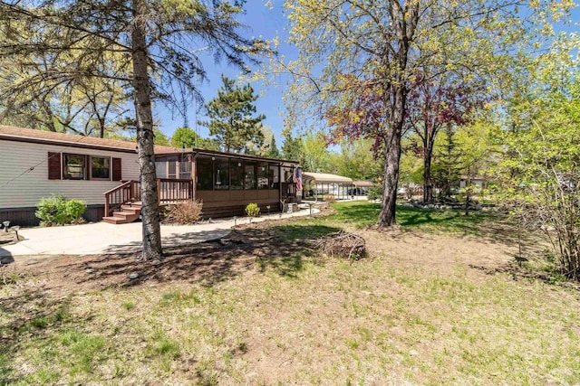 1870 County Road F Unit L69, Friendship, WI 53934 - view of grassy yard with a sunroom
