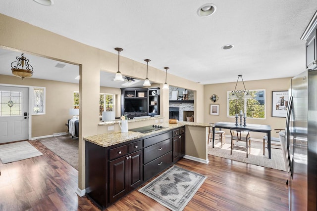 252 Willow Dr, Hartland, WI 53029 - kitchen with freestanding refrigerator, dark wood-style flooring, baseboards, open floor plan, and dark brown cabinetry