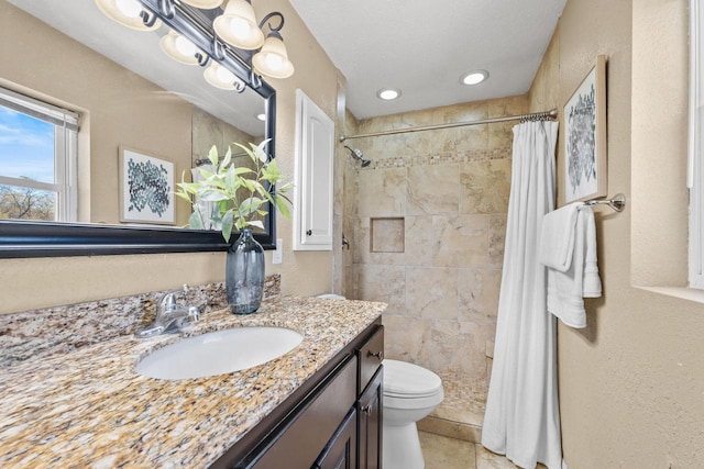252 Willow Dr, Hartland, WI 53029 - bathroom with a tile shower, toilet, vanity, and tile patterned flooring