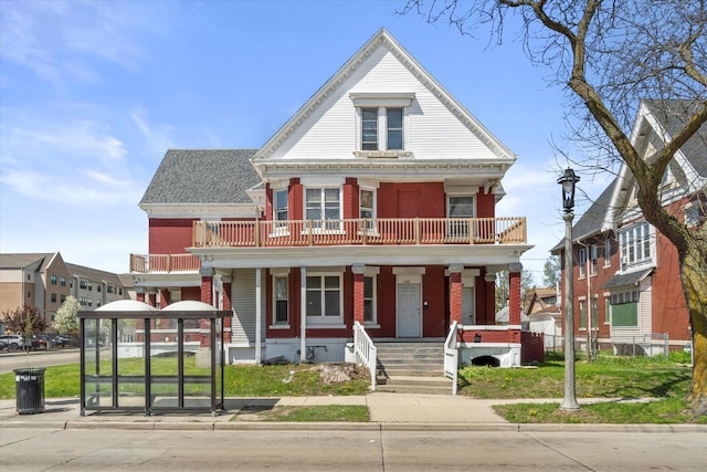 1341 S Layton Blvd Unit 1343, Milwaukee, WI 53215 - view of front of house featuring a balcony, covered porch, and brick siding