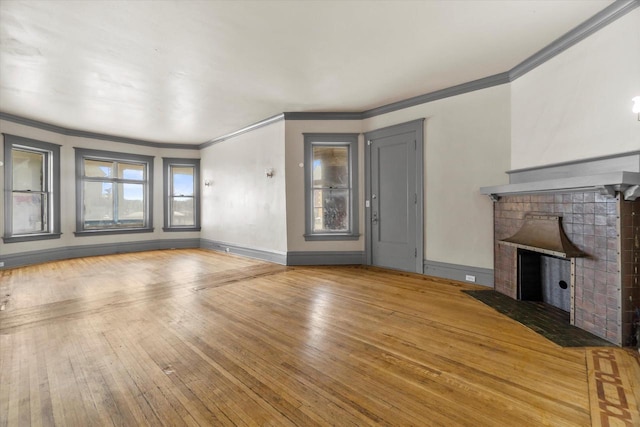 1341 S Layton Blvd Unit 1343, Milwaukee, WI 53215 - unfurnished living room with ornamental molding, hardwood / wood-style floors, a fireplace with flush hearth, and baseboards