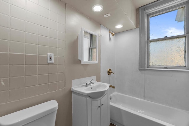 1341 S Layton Blvd Unit 1343, Milwaukee, WI 53215 - bathroom featuring toilet, vanity, and tub / shower combination