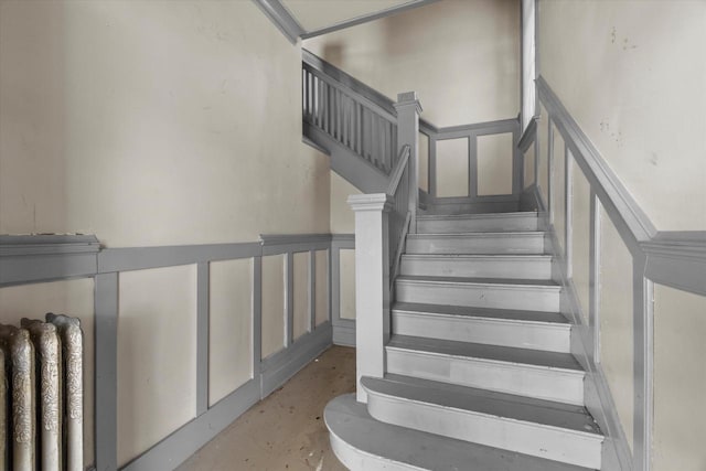 1341 S Layton Blvd Unit 1343, Milwaukee, WI 53215 - staircase with concrete floors, a decorative wall, and wainscoting