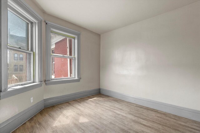 1341 S Layton Blvd Unit 1343, Milwaukee, WI 53215 - spare room with baseboards and wood finished floors
