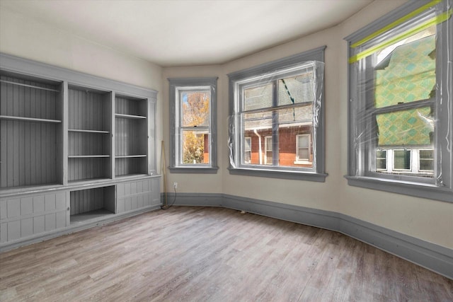 1341 S Layton Blvd Unit 1343, Milwaukee, WI 53215 - spare room featuring wood finished floors, plenty of natural light, and baseboards