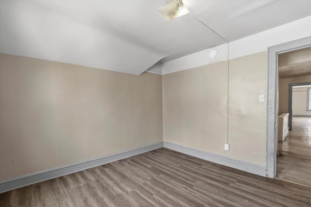 1341 S Layton Blvd Unit 1343, Milwaukee, WI 53215 - spare room with wood finished floors, baseboards, and lofted ceiling