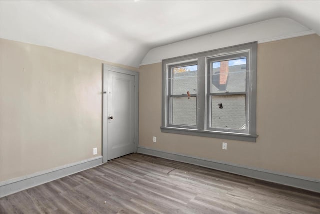 1341 S Layton Blvd Unit 1343, Milwaukee, WI 53215 - empty room with lofted ceiling, wood finished floors, and baseboards