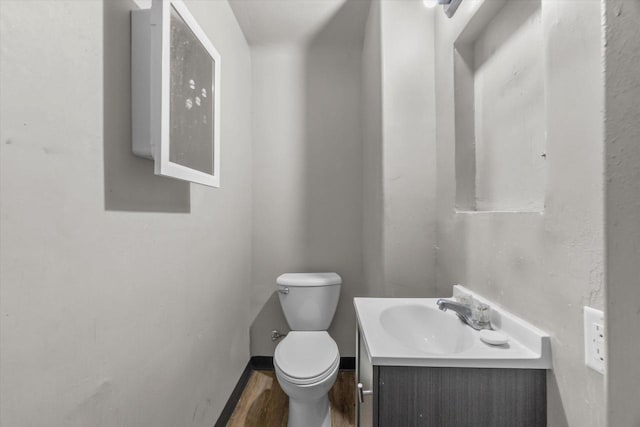 1341 S Layton Blvd Unit 1343, Milwaukee, WI 53215 - bathroom featuring toilet, vanity, baseboards, and wood finished floors