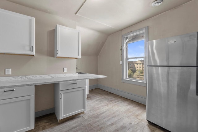 1341 S Layton Blvd Unit 1343, Milwaukee, WI 53215 - kitchen featuring freestanding refrigerator, white cabinets, light wood-style floors, lofted ceiling, and light stone countertops