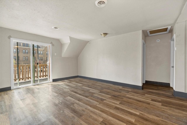 1341 S Layton Blvd Unit 1343, Milwaukee, WI 53215 - additional living space featuring wood finished floors, baseboards, attic access, and a textured ceiling
