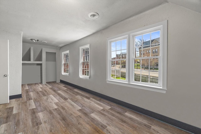 1341 S Layton Blvd Unit 1343, Milwaukee, WI 53215 - spare room with wood finished floors and baseboards