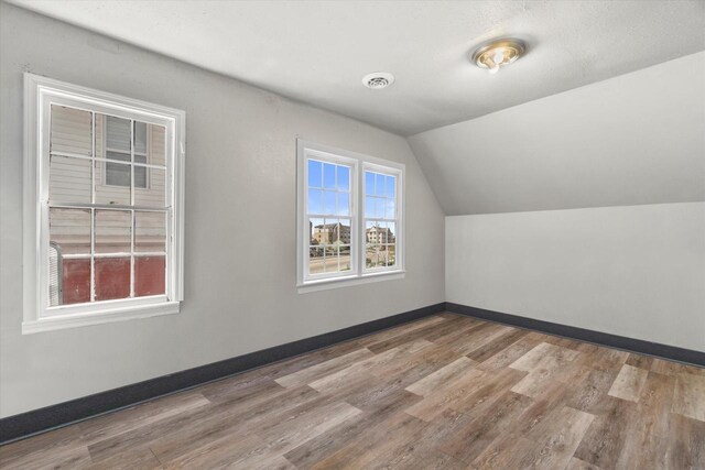 1341 S Layton Blvd Unit 1343, Milwaukee, WI 53215 - bonus room featuring wood finished floors, lofted ceiling, and baseboards
