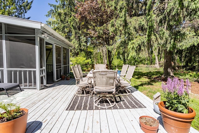 N56W27528 Lisbon Rd, Lisbon, WI 53089 - wooden terrace featuring a sunroom, outdoor dining space, and view of wooded area