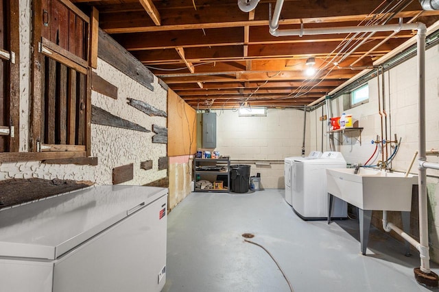 N56W27528 Lisbon Rd, Lisbon, WI 53089 - below grade area with washer and clothes dryer, electric panel, concrete block wall, and white fridge