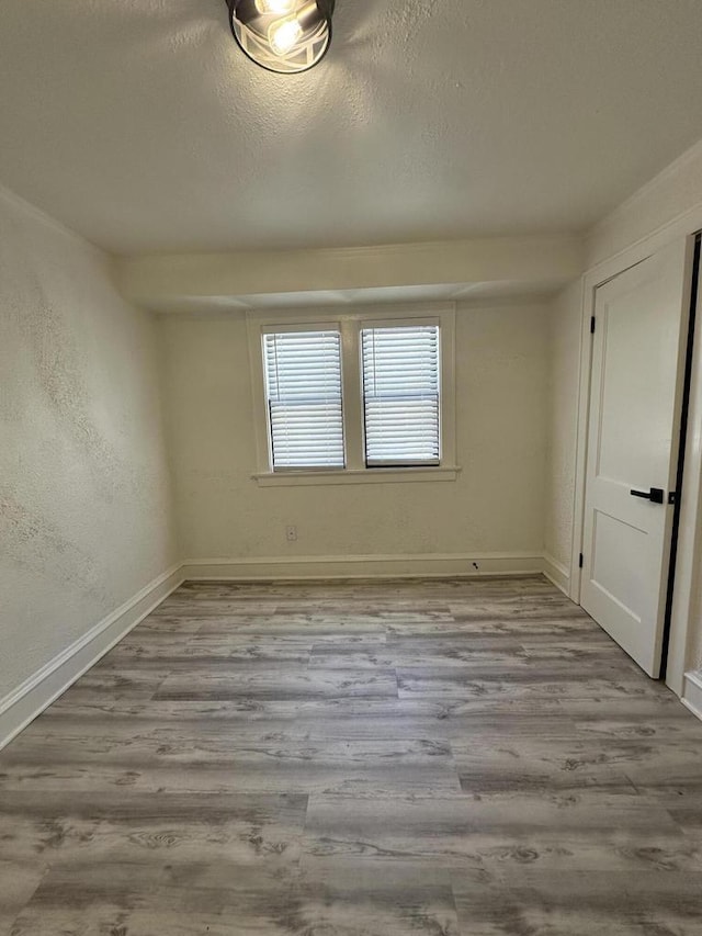 3158 N 39th St Unit 3160, Milwaukee, WI 53216 - spare room featuring wood finished floors, baseboards, and a textured ceiling
