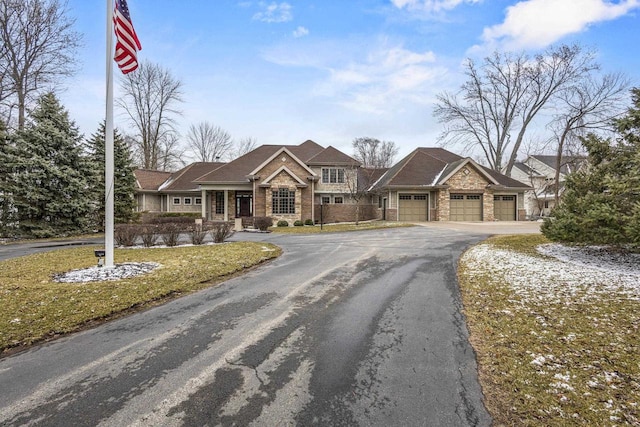 536 Sunrise Bay Rd, Neenah, WI 54956 - view of front of home with asphalt driveway, an attached garage, stone siding, and a front lawn