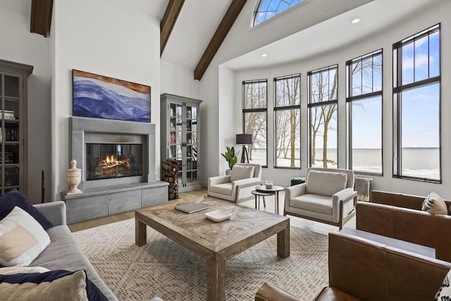 536 Sunrise Bay Rd, Neenah, WI 54956 - living room with a glass covered fireplace, wood finished floors, beamed ceiling, healthy amount of natural light, and high vaulted ceiling