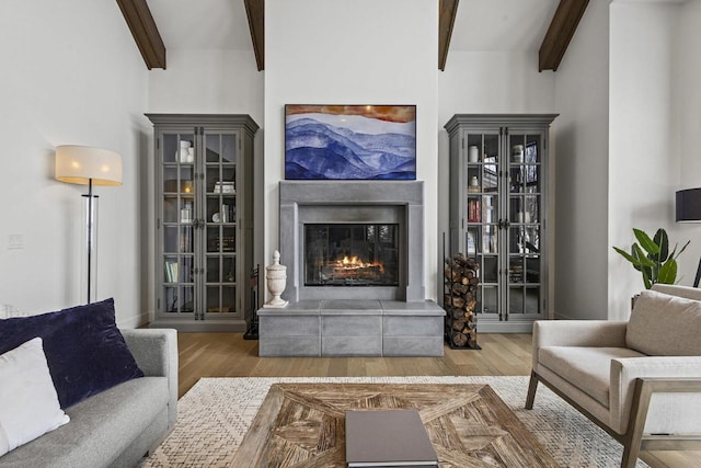 536 Sunrise Bay Rd, Neenah, WI 54956 - living area featuring beamed ceiling, wood finished floors, and a glass covered fireplace