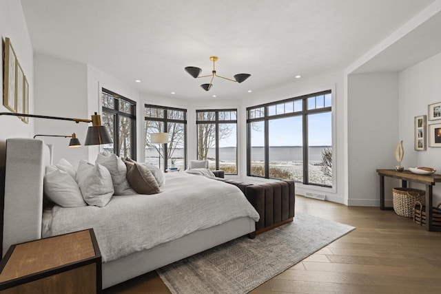 536 Sunrise Bay Rd, Neenah, WI 54956 - bedroom featuring a water view, recessed lighting, hardwood / wood-style flooring, and baseboards
