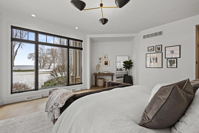 536 Sunrise Bay Rd, Neenah, WI 54956 - bedroom with wood finished floors, recessed lighting, and a water view