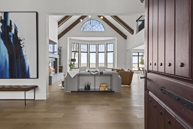 536 Sunrise Bay Rd, Neenah, WI 54956 - foyer with a glass covered fireplace, high vaulted ceiling, wood finished floors, and beam ceiling