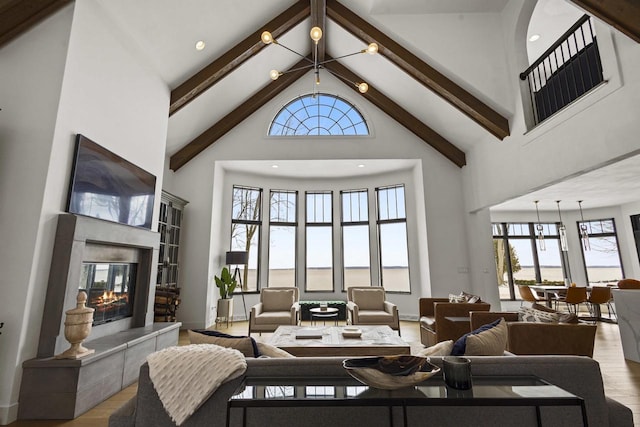 536 Sunrise Bay Rd, Neenah, WI 54956 - living room featuring high vaulted ceiling, a tiled fireplace, wood finished floors, beamed ceiling, and baseboards