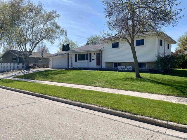 tri-level home featuring a garage and driveway