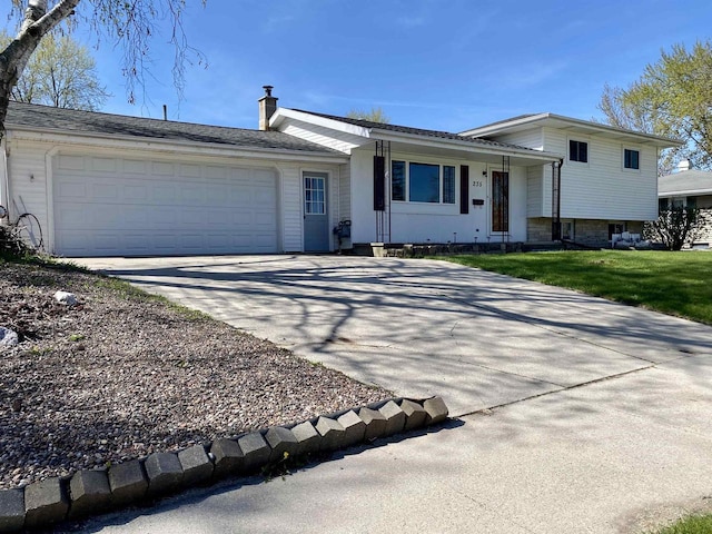 split level home featuring a garage and driveway